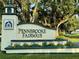 Elegant Pennbrooke Fairways entrance sign adorned with colorful flowers, welcoming you to a premier golf community at 32900 Crooked Oaks Ln, Leesburg, FL 34748