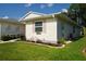 Charming home exterior with manicured lawn, pink shutters, and neatly landscaped flowerbeds at 32900 Crooked Oaks Ln, Leesburg, FL 34748