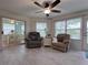 Comfortable Florida room with plush armchairs, bright windows, and access to the eat-in kitchen at 32900 Crooked Oaks Ln, Leesburg, FL 34748