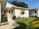 Charming home featuring a ramp, and cheerful pink shutters and door at 32900 Crooked Oaks Ln, Leesburg, FL 34748