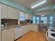 Bright eat-in kitchen featuring white cabinets, granite countertops, and a dining area with natural lighting at 32900 Crooked Oaks Ln, Leesburg, FL 34748