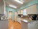 Functional kitchen with white appliances, light countertops, and easy access to the laundry and other rooms at 32900 Crooked Oaks Ln, Leesburg, FL 34748