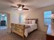 Comfortable main bedroom with carpet and views to the sunroom at 32900 Crooked Oaks Ln, Leesburg, FL 34748