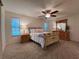 Comfortable main bedroom with carpet, ceiling fan, and dresser at 32900 Crooked Oaks Ln, Leesburg, FL 34748