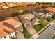 Aerial view of a home with a tile roof, three-car garage, paver driveway, and neatly kept lawn at 3647 Farm Bell Pl, Lake Mary, FL 32746