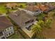 Aerial view showcases a home's backyard with a pool, patio seating, and a well-maintained landscape at 3647 Farm Bell Pl, Lake Mary, FL 32746