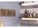 Close up of bar featuring spirits on floating shelves with custom wood paneling at 3647 Farm Bell Pl, Lake Mary, FL 32746
