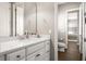 Bright bathroom with white vanity, quartz countertop, and wood-look tile at 3647 Farm Bell Pl, Lake Mary, FL 32746