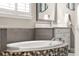 Bathroom featuring soaking tub with tile surround, and vanity with white cabinets and countertop at 3647 Farm Bell Pl, Lake Mary, FL 32746