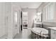 Bright bathroom featuring soaking tub with tile surround, walk-in shower, and access to bedroom at 3647 Farm Bell Pl, Lake Mary, FL 32746