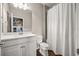 Neutral bathroom with white vanity, quartz countertop, and a shower with white shower curtain at 3647 Farm Bell Pl, Lake Mary, FL 32746