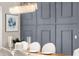 Chic dining area with wainscotting accent wall, stylish decor, and contemporary lighting at 3647 Farm Bell Pl, Lake Mary, FL 32746