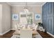 Elegant dining room with modern decor, a stylish chandelier, and a large window for natural light at 3647 Farm Bell Pl, Lake Mary, FL 32746