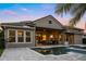 Gorgeous home exterior featuring a backyard pool, covered patio, and manicured landscaping at 3647 Farm Bell Pl, Lake Mary, FL 32746
