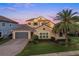 A two-story home features a three-car garage, a tile roof, and lush landscaping in a suburban setting at 3647 Farm Bell Pl, Lake Mary, FL 32746