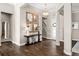 Elegant foyer with wood floors, decorative mirrors, stylish console table, and chandelier lighting at 3647 Farm Bell Pl, Lake Mary, FL 32746