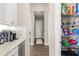 Hallway view featuring a view of the pantry and marble countertops with appliances at 3647 Farm Bell Pl, Lake Mary, FL 32746