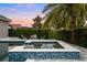 Stylish hot tub with mosaic tiling, surrounded by lush landscaping and an outdoor seating area at 3647 Farm Bell Pl, Lake Mary, FL 32746