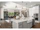 Island with quartz counters, pendant lighting, breakfast bar, and sink at 3647 Farm Bell Pl, Lake Mary, FL 32746