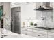 Close up of range, vent hood, refrigerator, sink, and faucet at 3647 Farm Bell Pl, Lake Mary, FL 32746