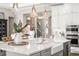 Kitchen island with breakfast bar, stainless appliances, and view to the entryway at 3647 Farm Bell Pl, Lake Mary, FL 32746