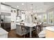 Bright kitchen with white cabinets, stainless steel appliances, granite counters and stylish barstool seating at 3647 Farm Bell Pl, Lake Mary, FL 32746