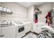 Functional laundry room with washer, dryer, sink, and ample storage space at 3647 Farm Bell Pl, Lake Mary, FL 32746
