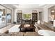 Spacious living room featuring a large sectional, decorative cabinets, and seamless access to an outdoor space at 3647 Farm Bell Pl, Lake Mary, FL 32746