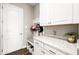 Convenient mud room with storage cabinets, bench, and hooks for organization near entry at 3647 Farm Bell Pl, Lake Mary, FL 32746