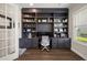 Spacious home office featuring custom built-ins, shelving and modern chair at 3647 Farm Bell Pl, Lake Mary, FL 32746