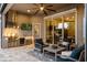A covered patio with a full kitchen, comfortable seating, and a ceiling fan overlooking the sparkling pool at 3647 Farm Bell Pl, Lake Mary, FL 32746