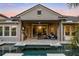 A stunning outdoor living space featuring a pool, covered patio with a built-in grill, and ample seating at 3647 Farm Bell Pl, Lake Mary, FL 32746