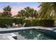 Backyard pool and spa with outdoor furniture, firepit, and mature trees at 3647 Farm Bell Pl, Lake Mary, FL 32746