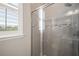 Walk-in shower with glass door and decorative accent tiles at 3647 Farm Bell Pl, Lake Mary, FL 32746