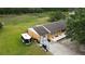 Aerial view of a home showcasing a spacious backyard, a stone patio, and an attached garage at 3713 N Econlockhatchee Trl, Orlando, FL 32817