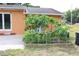 Backyard garden bed shows off lush papaya plants and is steps away from door and patio at 3713 N Econlockhatchee Trl, Orlando, FL 32817