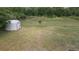 Expansive backyard with storage shed, mature trees and lush green grass offers space for relaxation at 3713 N Econlockhatchee Trl, Orlando, FL 32817