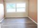 Neutral bedroom with wood-look floors, natural light, and a serene, inviting ambiance at 3713 N Econlockhatchee Trl, Orlando, FL 32817