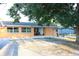 A lovely home with neutral exterior paint, a cozy front porch, and an inviting outdoor seating area at 3713 N Econlockhatchee Trl, Orlando, FL 32817