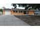 Charming one-story home featuring an attached garage, neutral paint, and a spacious front yard at 3713 N Econlockhatchee Trl, Orlando, FL 32817