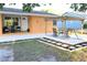 Charming outdoor space with a stone-paved patio, pergola, and stepping stones, perfect for relaxation at 3713 N Econlockhatchee Trl, Orlando, FL 32817