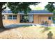 Inviting home exterior with a patio seating area and a pergola-covered outdoor dining space at 3713 N Econlockhatchee Trl, Orlando, FL 32817