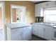 Bright kitchen features white cabinets, granite countertops, and a stylish tile backsplash at 3713 N Econlockhatchee Trl, Orlando, FL 32817