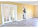 Bright living room featuring wood-look floors, white trim, and glass French doors for a modern look at 3713 N Econlockhatchee Trl, Orlando, FL 32817