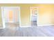 Inviting living room with wood-look floors and doorways providing access to other rooms of the house at 3713 N Econlockhatchee Trl, Orlando, FL 32817
