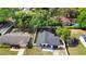 Aerial view of a cozy home with a fenced yard, featuring a well-maintained lawn and mature trees at 376 Orange Ave, Longwood, FL 32750