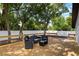 Relaxing back deck area with stylish seating, fire pit, and hammock for leisure and comfort at 376 Orange Ave, Longwood, FL 32750