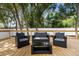 The back deck features stylish seating with a love seat, two chairs, and a glass coffee table at 376 Orange Ave, Longwood, FL 32750