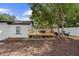 Backyard featuring a wooden deck, perfect for outdoor enjoyment and relaxation under the shade of mature trees at 376 Orange Ave, Longwood, FL 32750