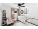 Charming Bedroom with pink accents, featuring a crib, dresser, rocker, and decorative elements at 376 Orange Ave, Longwood, FL 32750